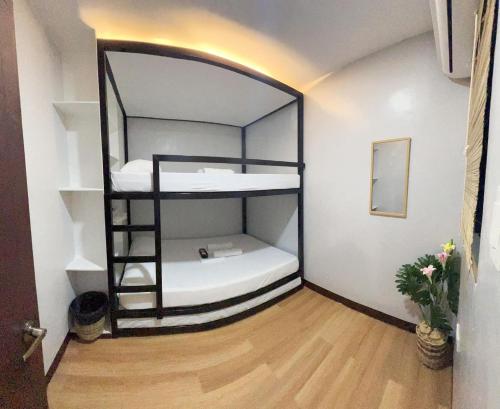 a room with a bunk bed with a ladder at Haidoville in General Luna