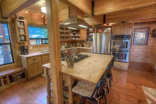 a kitchen with a large island in a log cabin at Smokey Joes cabin in Zephyr Cove