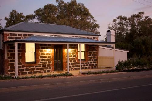 a brick house with lights on it on a street at The Cottage in Tanunda