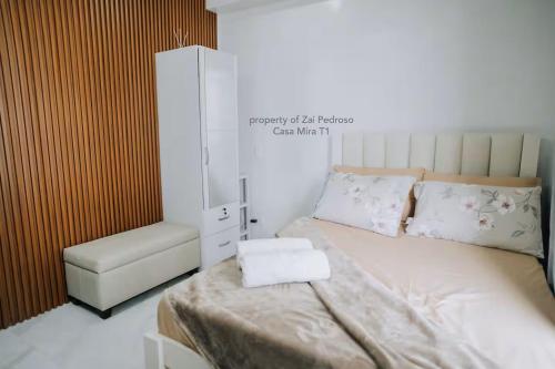 a small bedroom with a bed and a chair at Minimalist Haven, Maximum Cebu Fun! in Cebu City