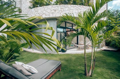 a palm tree in the yard of a house at Boho Jungle Villa - Pvt Pool -100mbs- Concierge 7A in Tulum