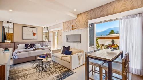 a bedroom with a bed and a living room at Stunning Beachfront Condo - Sea Views & Pools in Puerto Vallarta
