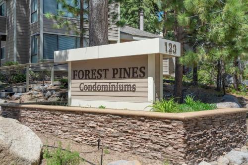 a sign for a forest pines apartment building at Raccoon Roost condo in Incline Village