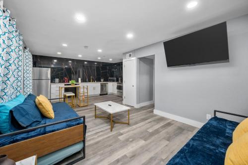 a living room with a couch and a flat screen tv at Chic Heights Retreat with Pool and Free Parking in Houston