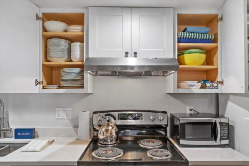 a kitchen with a stove and a microwave at Raccoon Roost condo in Incline Village