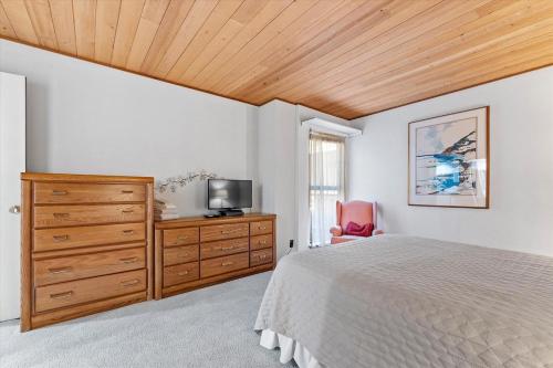 a bedroom with a bed and a dresser and a tv at Raccoon Roost condo in Incline Village