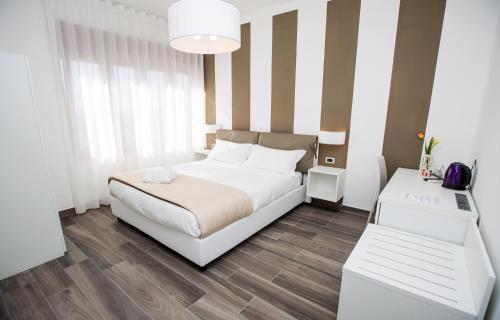 a bedroom with a white bed and a table at Sea Room Sorrento in Sorrento