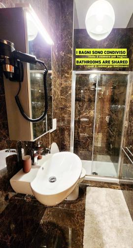 a bathroom with a sink and a shower at Luna di Pisa in Pisa
