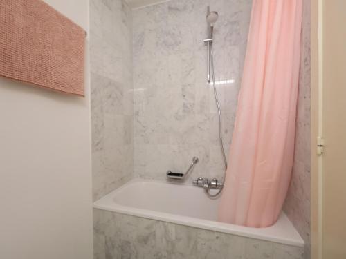 a bathroom with a shower with a bath tub at Studio by the Beach with Sea View in Oostduinkerke