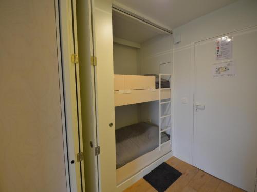 a small room with a bunk bed and a closet at Studio in Belgium near Beach & Dunes in Oostduinkerke