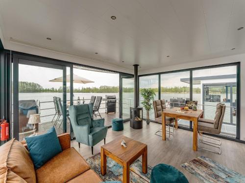 a living room with a view of the water at Havel Houseboat Serenity in Zehdenick