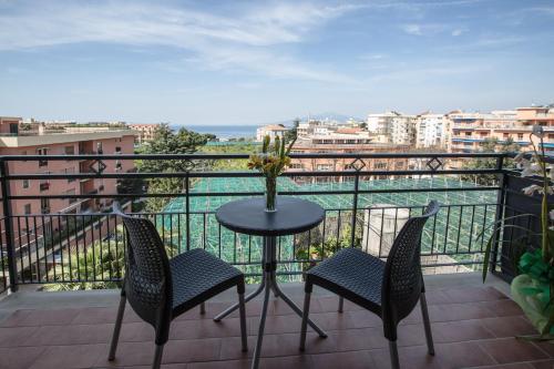 a table and chairs on a balcony with a view at Sea Room Sorrento in Sorrento