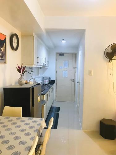 a kitchen with a table and a dining room at CHIC ROOM pasay sea residence in Manila