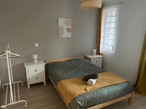 a bedroom with a bed with a teddy bear on it at Appartement 4 personnes Proche Centrex & Disneyland in Noisy-le-Grand