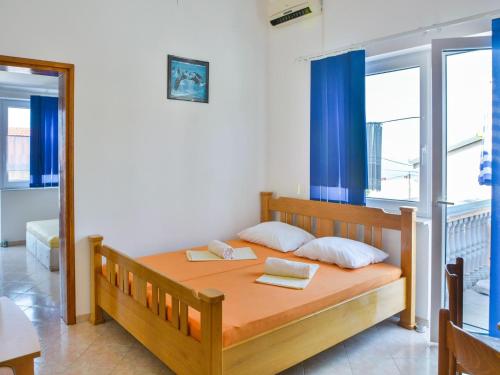 a bedroom with a bed with two books on it at Apartment in Croatia near Adriatic Coast in Senj