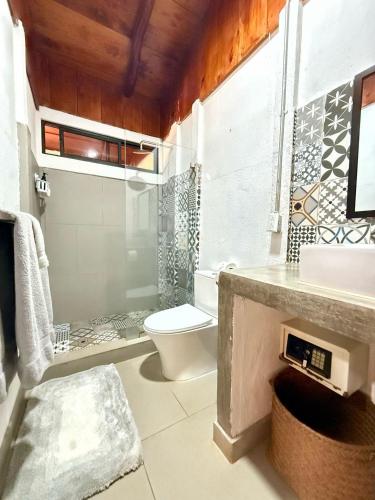 a bathroom with a toilet and a sink and a mirror at Minutes away to the beach ¨Playa Blanca¨ in Paraíso