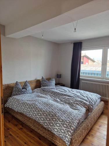 a bedroom with a bed and a large window at Wohnen wie zu Hause in Lauterbach