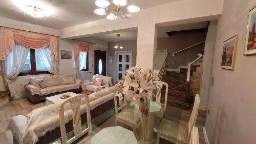 a living room with a couch and a table at Lux Center Apartment in Litochoro