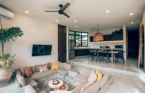 a living room with a couch and a table at Boho Jungle Villa - Pvt Pool -100mbs- Concierge 7A in Tulum
