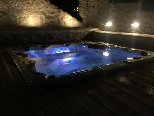 a jacuzzi tub with blue lights in a cave at Chiesa Ignano 1778 in Marzabotto