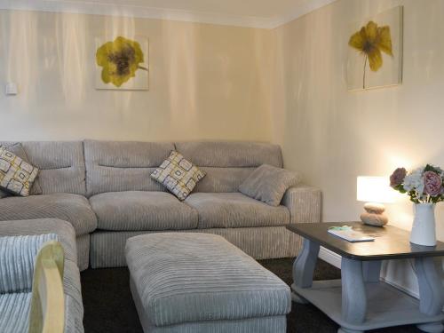a living room with a couch and a table at Alderson Mews in Brigham