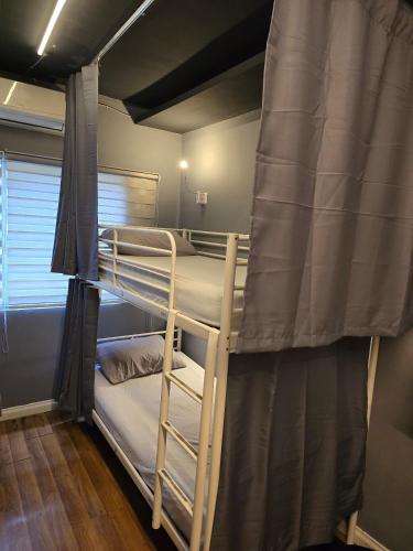a couple of bunk beds in a room at Travelogue Guest House in Kuala Lumpur