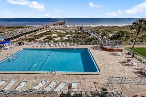 a swimming pool with a view of the beach at Oceanfront Condo w Balcony in Amelia Island