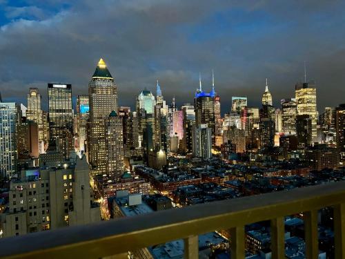 a view of a city skyline at night at Midtown High Floor Fantastic Panoramic City View Corner 2 Bedroom Apartment in New York