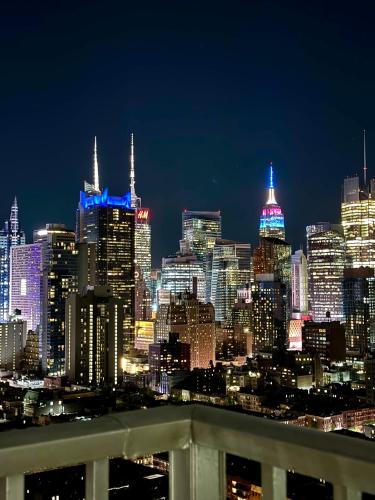 a view of a city skyline at night at Midtown High Floor Fantastic Panoramic City View Corner 2 Bedroom Apartment in New York