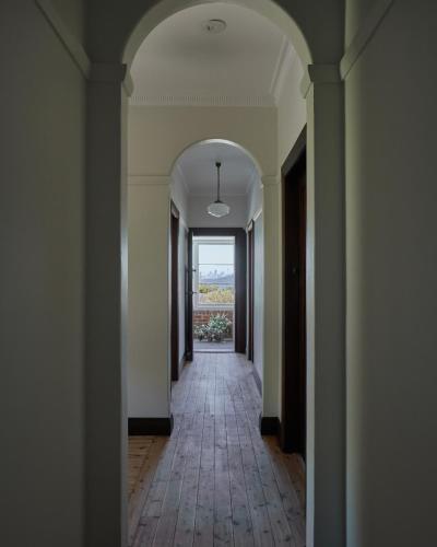 an empty hallway with an archway in a building at Q Station in Sydney