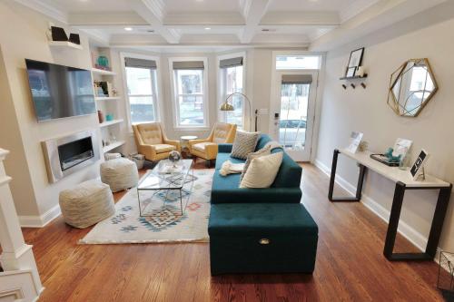 a living room with a couch and a table at Stroll to The Hip Strip From Shaw Basement Suite in Washington, D.C.