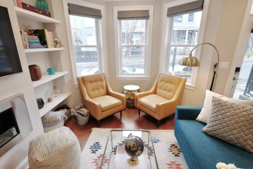 a living room with two chairs and a couch at Stroll to The Hip Strip From Shaw Basement Suite in Washington, D.C.