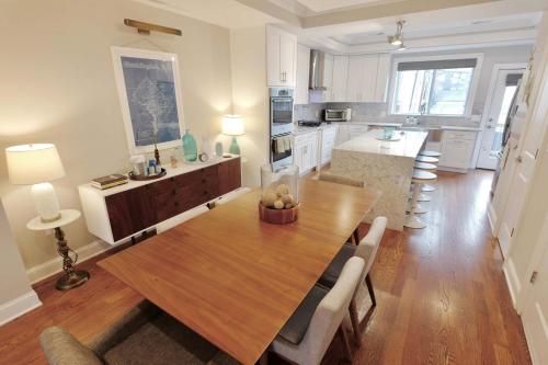 a kitchen and dining room with a wooden table at Stroll to The Hip Strip From Shaw Basement Suite in Washington, D.C.