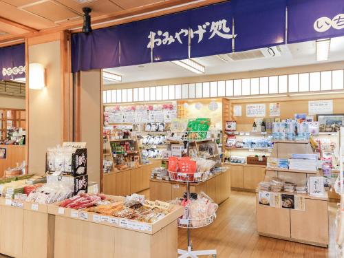 a grocery store with a blue sign above the counter at Ichinomata Onsen Grand Hotel in Shimonoseki
