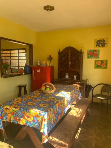 a bedroom with a bed with a colorful bedspread at Chácara do Maurão - tranquility and nature in Serra Negra