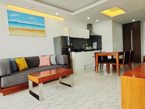 a living room with a couch and a table at Jeju Breeze in Seogwipo