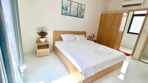 a small bedroom with a bed and a window at Hotel & Homestay Long Vũ Măng Đen in Kon Tum