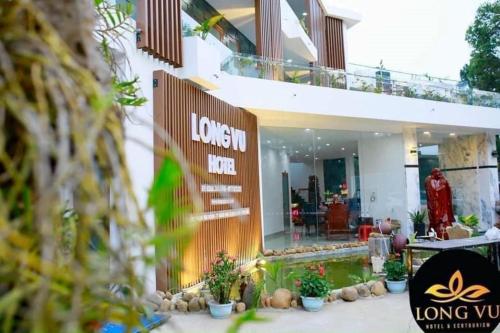 a building with a lot of plants in front of it at Hotel & Homestay Long Vũ Măng Đen in Kon Tum