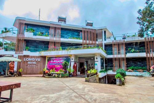 a large building with a lot of plants in it at Hotel & Homestay Long Vũ Măng Đen in Kon Tum