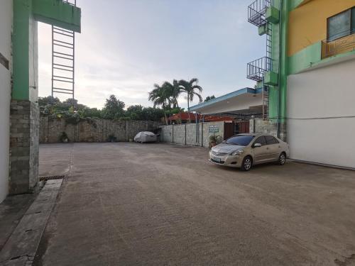 a car parked in a parking lot next to a building at Metro Park Hotel - Cebu City in Cebu City
