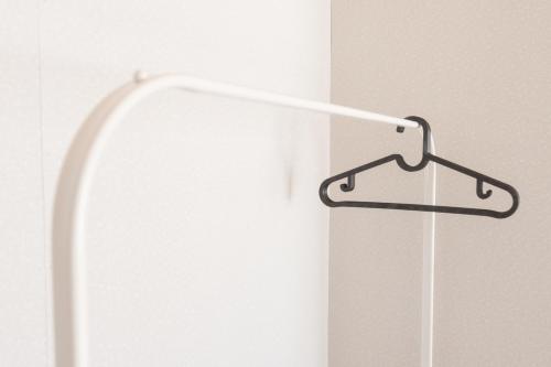 a white refrigerator with a hanger on a wall at +C FURANO in Furano