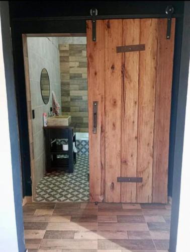 a large wooden door in a room with a table at El Cardo in General Belgrano