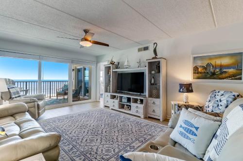 a living room with a couch and a tv at C5 Amelia South condo in Fernandina Beach