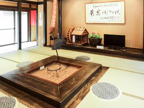 a room with a table in the middle of the floor at Ichinomata Onsen Grand Hotel in Shimonoseki