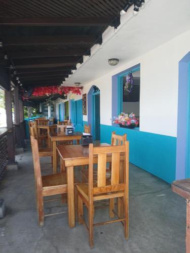 a dining room with wooden tables and chairs at Hotel Casa Amelia in Flores
