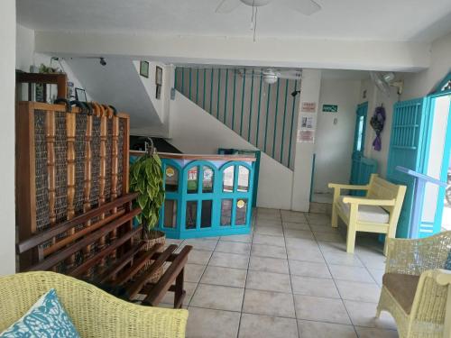 a room with a staircase and a table and chairs at Hotel Casa Amelia in Flores