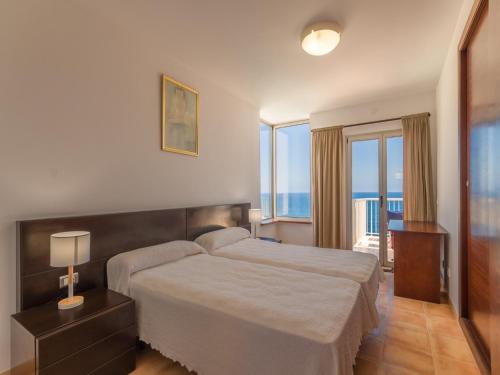 a bedroom with a large bed with a view of the ocean at Cozy Vista Mar Azul in Cala Murada in Cala Murada