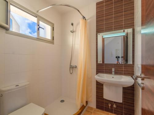 a bathroom with a sink and a toilet and a mirror at Cozy Vista Mar Azul in Cala Murada in Cala Murada