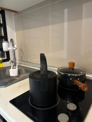 a pot and a knife on a stove in a kitchen at Mount Austin Lake View in Johor Bahru
