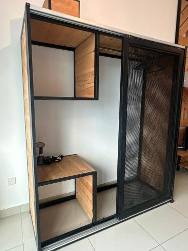 a room with a closet with a wooden shelf at Mount Austin Lake View in Johor Bahru